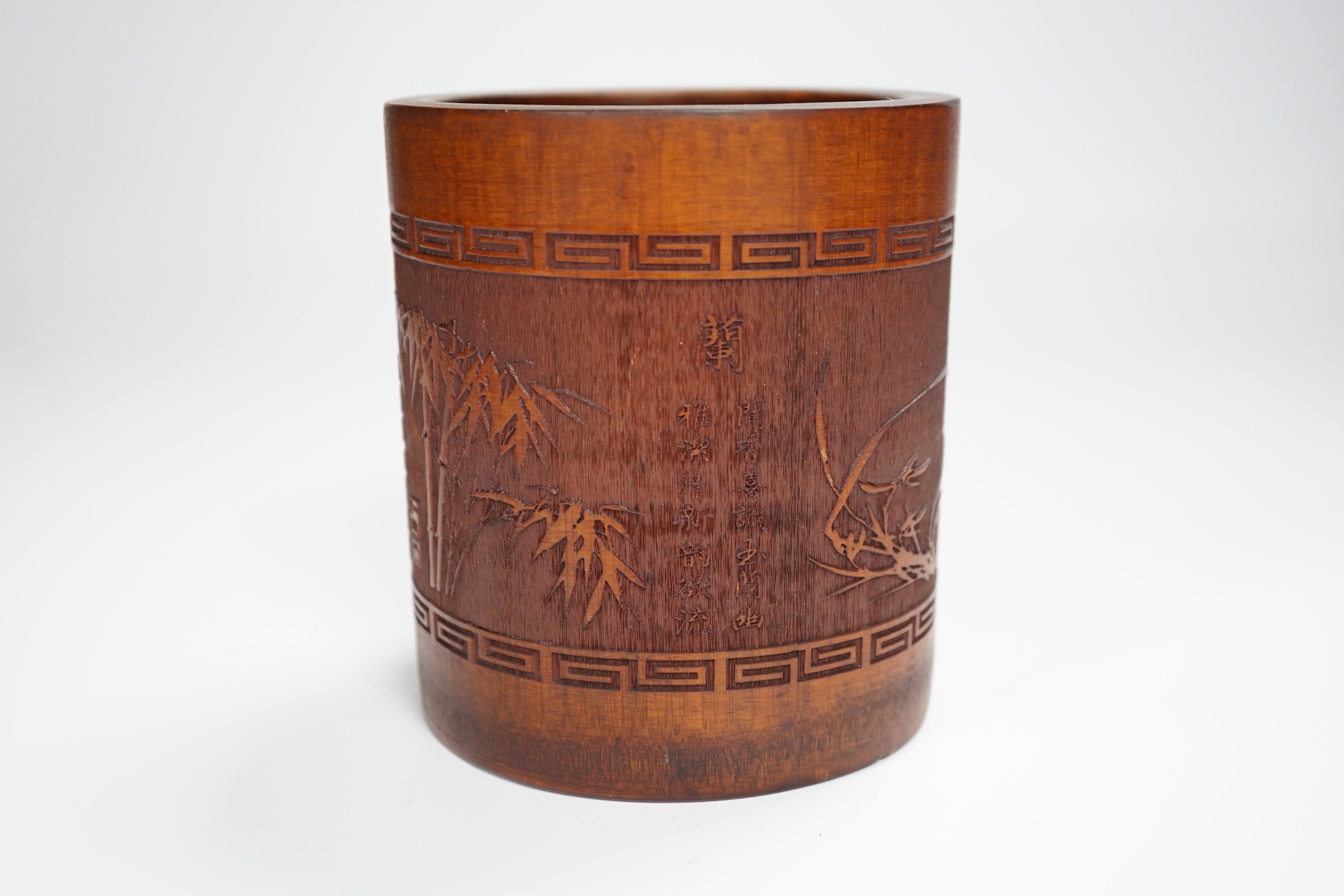 A 20th century bamboo bitong, carved with Chinese characters, bamboo and other foliage, 11.5cm high